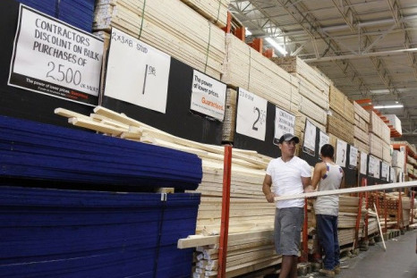People shop for lumber at a Home Depot store in New York