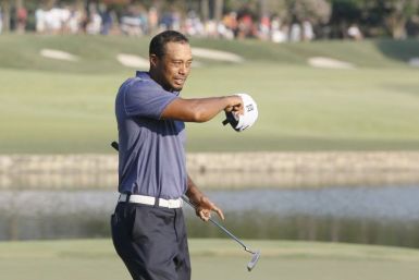 Tiger Woods of the U.S. takes off his hat after completing the 18th hole, finishing play in the second round of the 93rd PGA Championship golf tournament at the Atlanta Athletic Club in Johns Creek