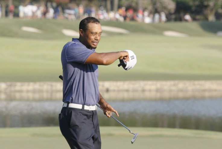 Tiger Woods of the U.S. takes off his hat after completing the 18th hole, finishing play in the second round of the 93rd PGA Championship golf tournament at the Atlanta Athletic Club in Johns Creek