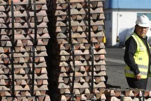 A security guard stands next to a shipment of copper ready to be delivered in Valparaiso city