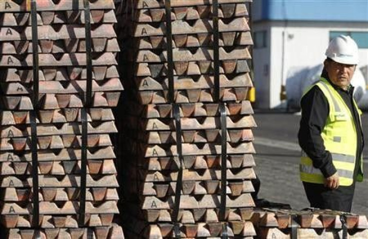 A security guard stands next to a shipment of copper ready to be delivered in Valparaiso city