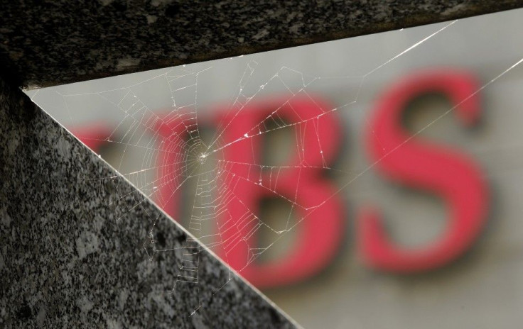 A cobweb is seen in front of the logo of Swiss bank UBS in Zurich
