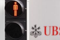 A traffic sign is seen next to an UBS logo in Zurich