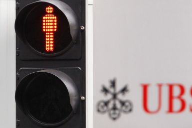 A traffic sign is seen next to an UBS logo in Zurich