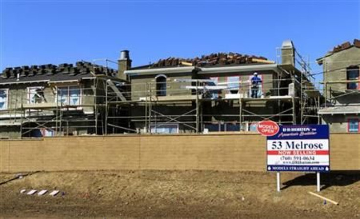 Construction workers continue work on a new subdivision of homes in San Marcos, California