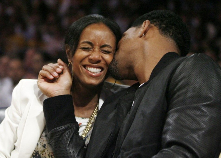 Actor Will Smith kisses his wife Jada Pinkett-Smith