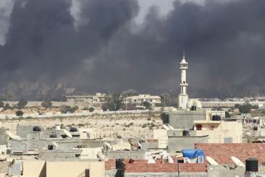 Smoke rises above downtown Tripoli following fighting at Bab Al-Aziziya compound