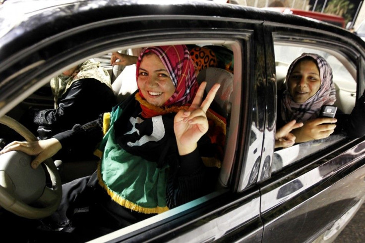 A woman flashes a victory sign during celebrations in Green Square, renamed Martyrs Square by rebels, in Tripoli