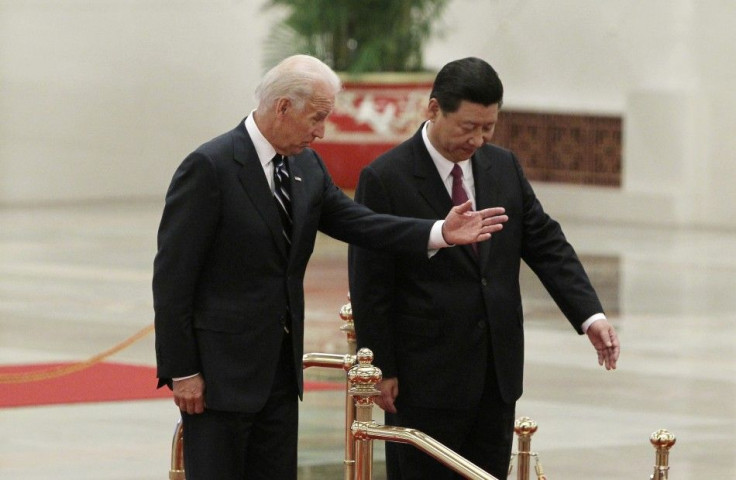 U.S. Vice President Biden gestures to his Chinese counterpart Xi during a welcome ceremony at the Great Hall of the People in Beijing