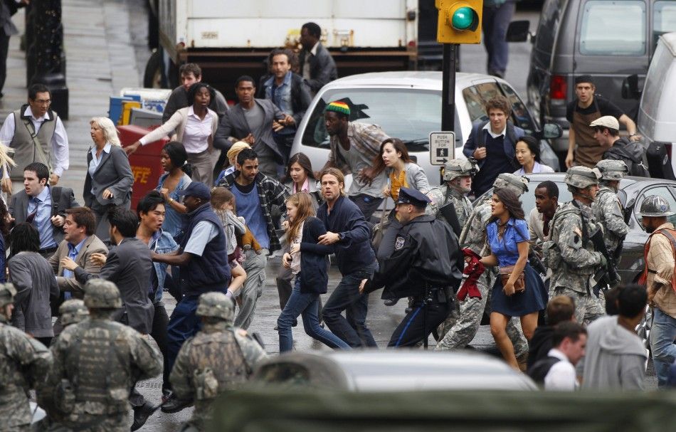 Actor Brad Pitt C runs during the filming of zombie movie World War Z in Glasgow, Scotland 