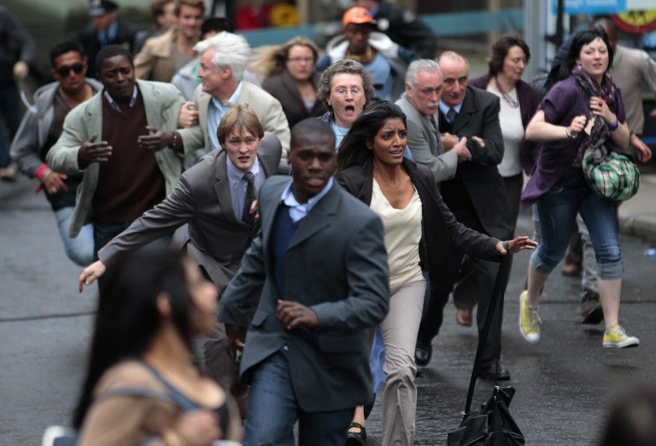 Extras in the zombie movie quotWorld War Zquot run along a street during filming in Glasgow, Scotland 