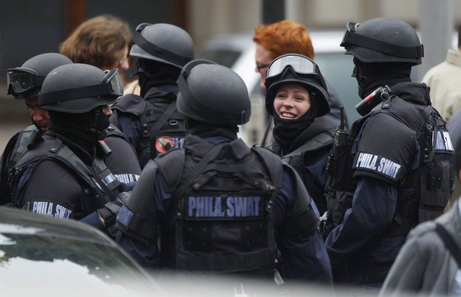 Extras dressed as SWAT police stand together during the filming of zombie movie World War Z in Glasgow, Scotland 