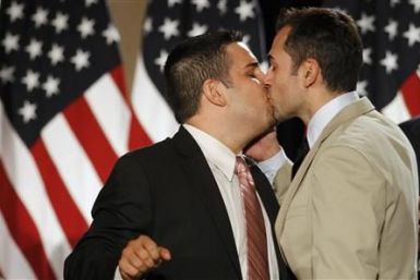 Jeff Zarrillo kisses his partner Paul Katami during a news conference in San Francisco following a decision by US District Judge Vaugh Walker that says Proposition 8 violates gays&#039; and lesbians&#039; rights of equality