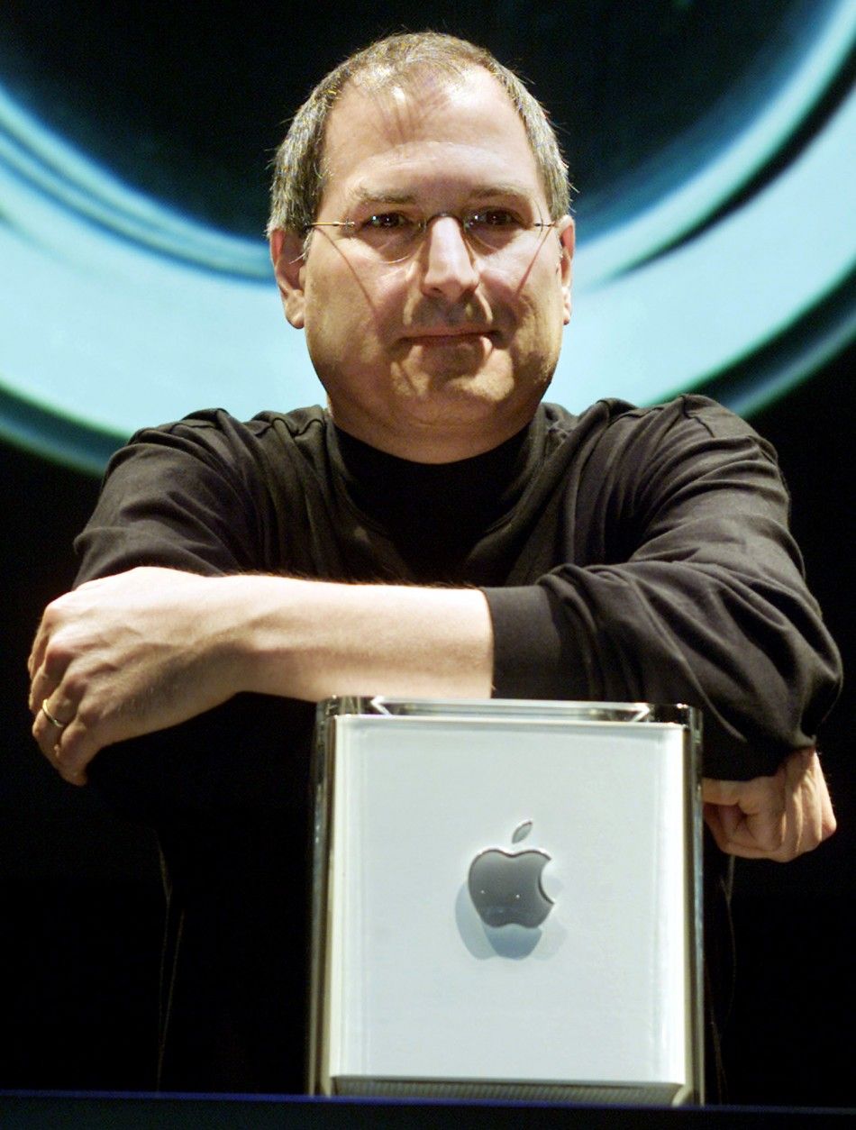 Apple Computer Inc. founder Steve Jobs poses with the companys new Power Mac G4 Cube, after his keynote adddress at the Macworld Conference and Exposition in New York 