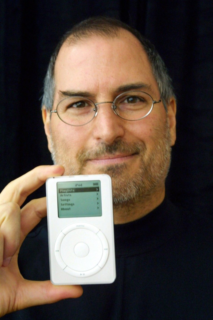 Apple Computer CEO Steve Jobs holds up the new Apple release in Cupertino, California 