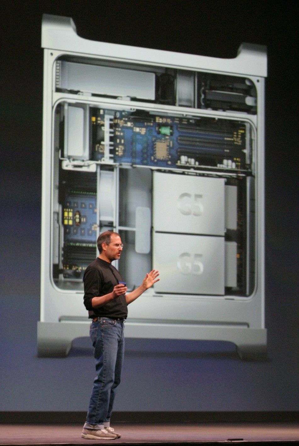 With the new Apple Power Mac G5 personal computer projected behind him, Apple CEO Steve Jobs introduces the new computer at the Apple World Wide Developers Conference in San Francisco
