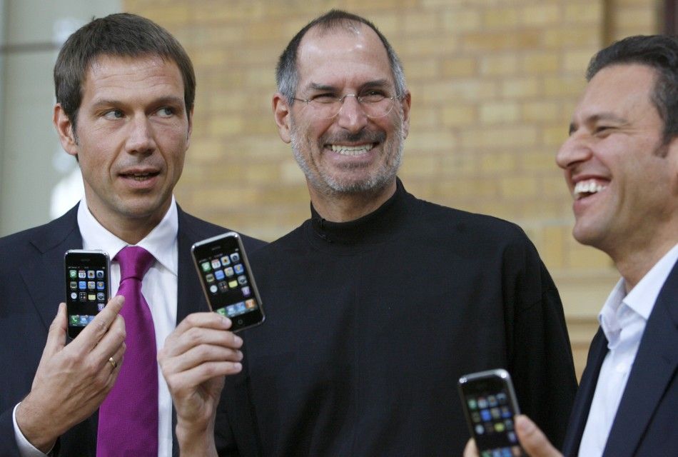 Deutsche Telekom AG Chief Executive Officer Rene Obermann, Apple Chief Executive Steve Jobs and T-Mobile Chief Executive Hamid Akhavan L-R pose for the media following their introduction of Apples iPhone in Berlin 