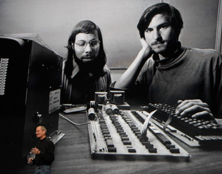 Apple Chief Executive Officer Steve Jobs stands beneath a photograph of him and Apple-co founder Steve Wozniak from the early days of Apple during the launch of Apple's new &quot;iPad&quot; tablet computing device in San Francisco, California