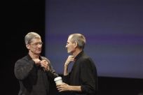 Apple COO Tim Cook and CEO Steve Jobs remove their microphones after a news conference at Apple headquarters in Cupertino
