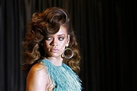 Singer Rihanna poses during the launch of her fragrance ''Reb'l fleur'' at a House of Fraser department store on Oxford Street in London