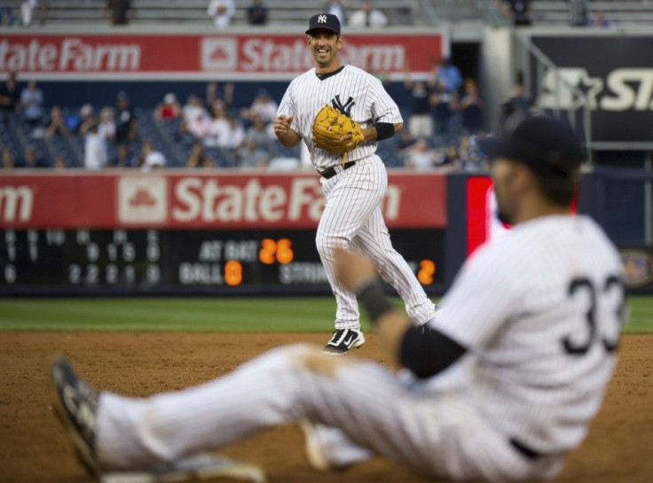 Yankees&#039; Posada grins as he threw out Athletics&#039; Recker for the final out in New York