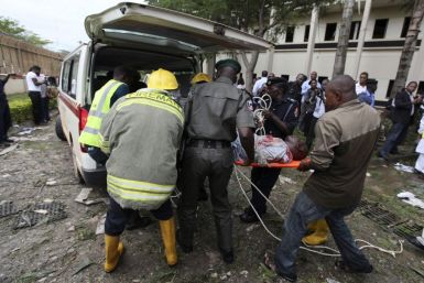 A victim of a bomb blast ripped through the United Nations offices in the Nigerian capital of Abuja is loaded into an ambulance