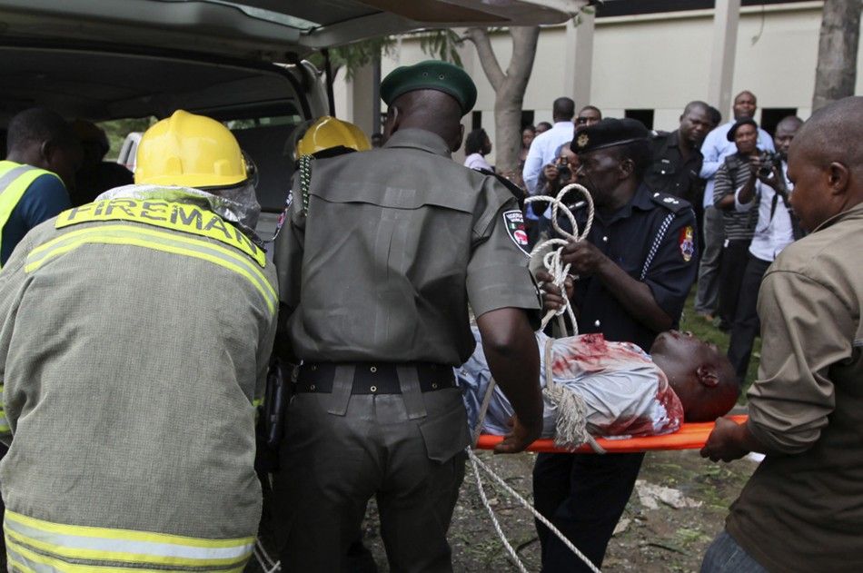A victim of a bomb blast that ripped through the United Nations offices in the Nigerian capital of Abuja is loaded into an ambulance