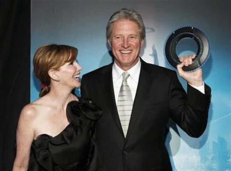Cast member Bruce Boxleitner holds an Identity Disc as he poses with his wife Melissa Gilbert at the world premiere of the film &quot;TRON: Legacy&quot; in Hollywood, California