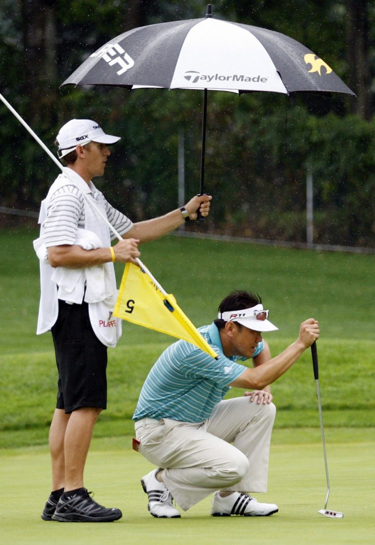 Charlie Wi of South Korea lines up his putt on the fifth green during the first round of The Barclays golf tournament in Edison