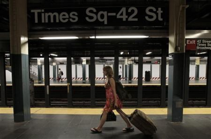 A woman walks through the Times Square subway station after the last subway has left