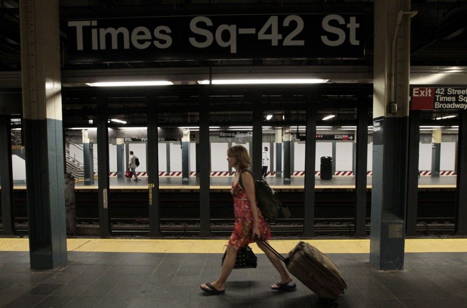 A woman walks through the Times Square subway station after the last subway has left