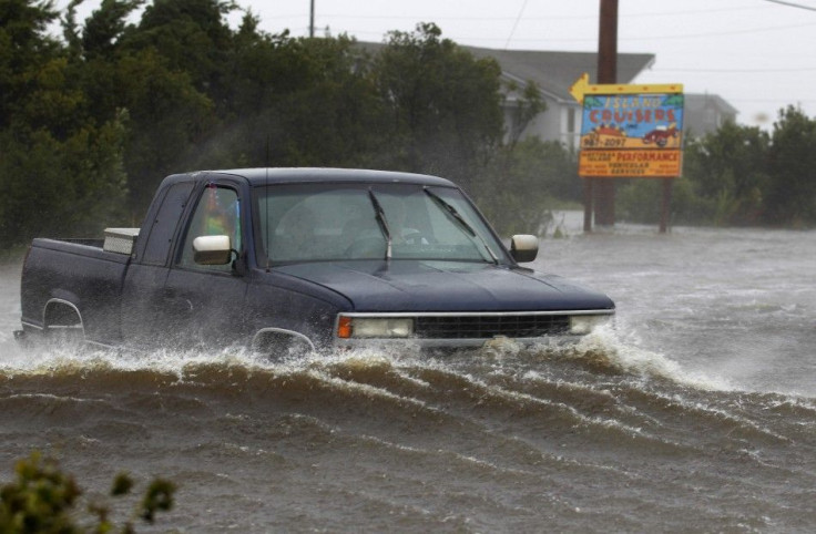 A truck drives through flooded road as Hurricane Irene hits Cape Hatteras National Seashore in Salvo