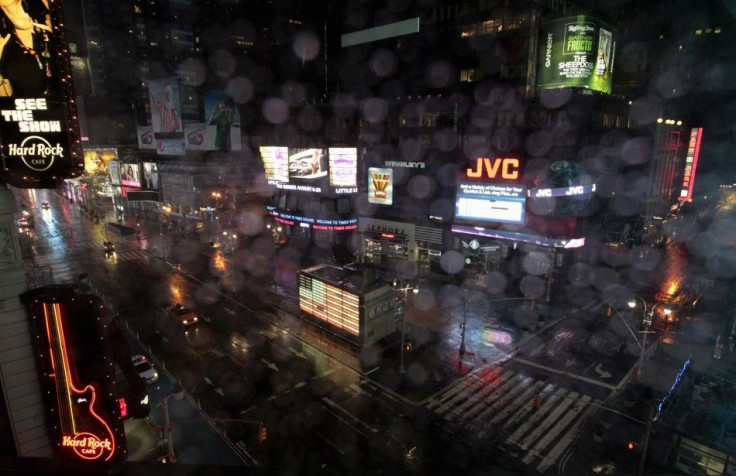 New York City taxicabs drive through a nearly empty Times Square in New York