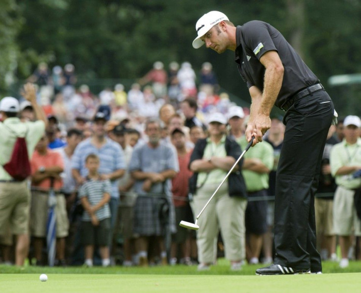 Dustin Johnson of the U.S. follows through as he putts on the 13th green during the third and final round of the hurricane-shortened Barclays golf tournament in Edison