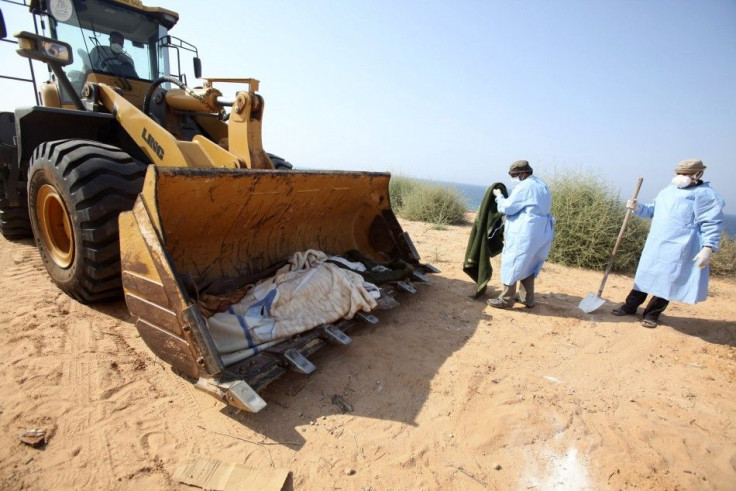 Volunteers collect the decomposed bodies of African mercenaries from the Gaddafi brigades who were killed during fighting with rebels in Tadjoura