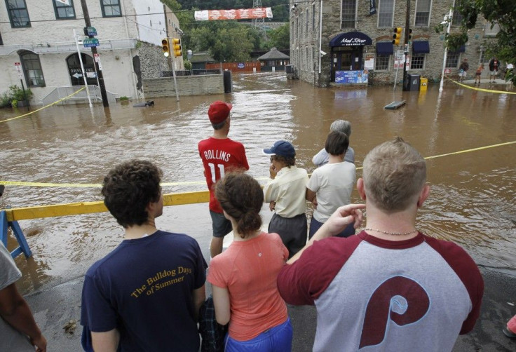 Residents watch the flooded streets in the Philadelphia neighborhood of Manayunk after Hurricane Irene