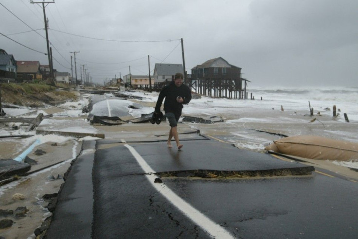 A resident walks over the buckled highway 12 after Hurricane Isabel plowed into Kitty Hawk on the Outer Banks of North Carolina