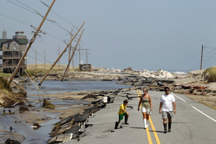 Residents walk along North Carolina's Highway 12 after Hurricane Irene