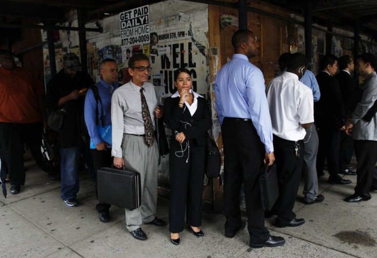 People wait in line to enter a job fair in New York