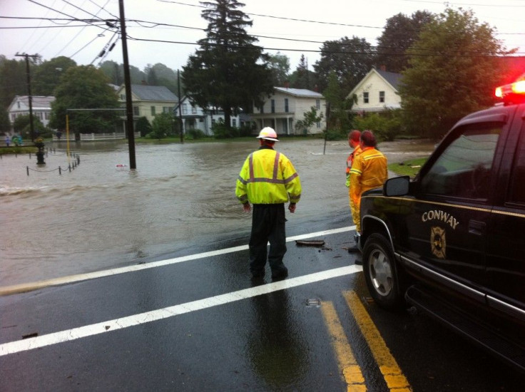Conway, Massachusetts city personnel look at flooding from the South River