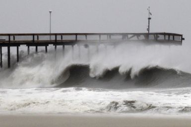 Waves break along the pier which was damaged during Hurricane Irene, in Ocean City