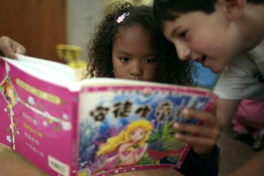 Aniya Cope and Ryan Goss, 5, read a Chinese book at Broadway Elementary School in Venice, Los Angeles