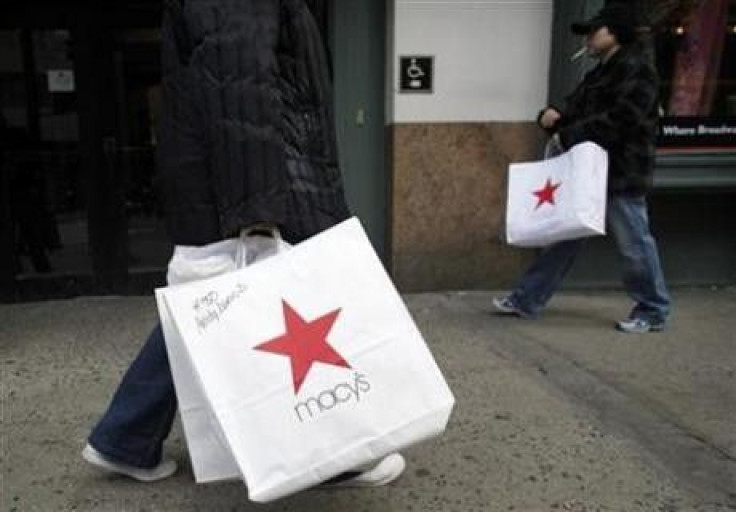 Shoppers carry shopping bags, after buying goods at Macy's flagship department store in Herald Square in New York 