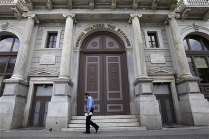 A man walks in front of the headquarters of National Bank of Greece in Athens