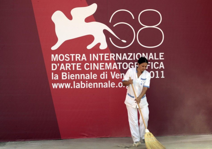 Worker cleans in front of sign in Venice