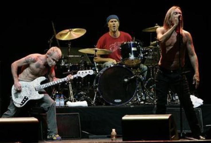 Flea (L) and drummer Chad Smith (C) of the Red Hot Chili Peppers (RHCP) and Iggy Pop perform at the Musicares MAP Fund benefit concert in Los Angeles