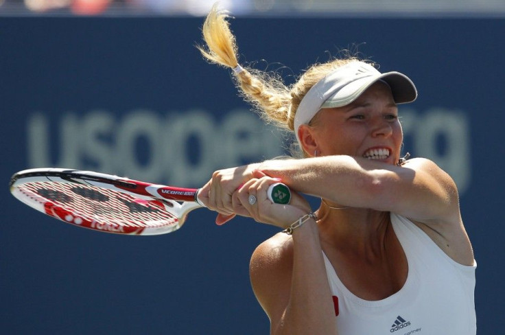 Caroline Wozniacki of Denmark hits a return to Nuria Llagostera Vives of Spain during their match at the U.S. Open tennis tournament in New York