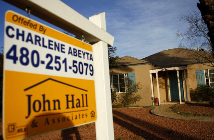 A realtor sign is displayed near a house for sale in Phoenix