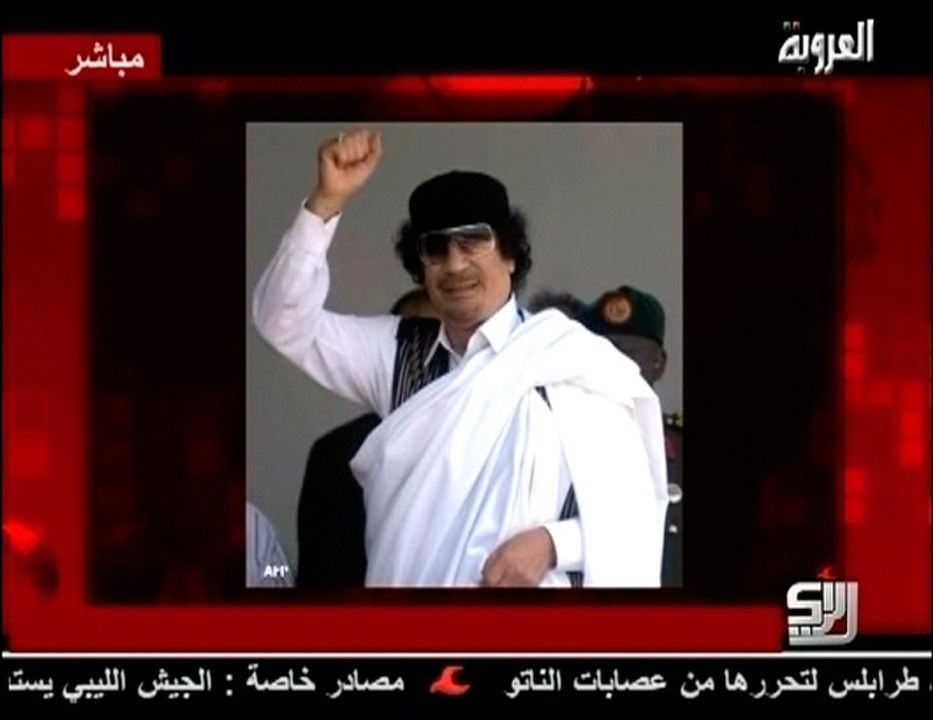 A still image of Libyan leader Moammar Gadhafi is displayed to accompany his audio message broadcast by Syrian TV channel Al-Orouba