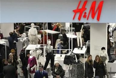 People shop in the newly opened Hennes & Mauritz (H&M) store in Moscow